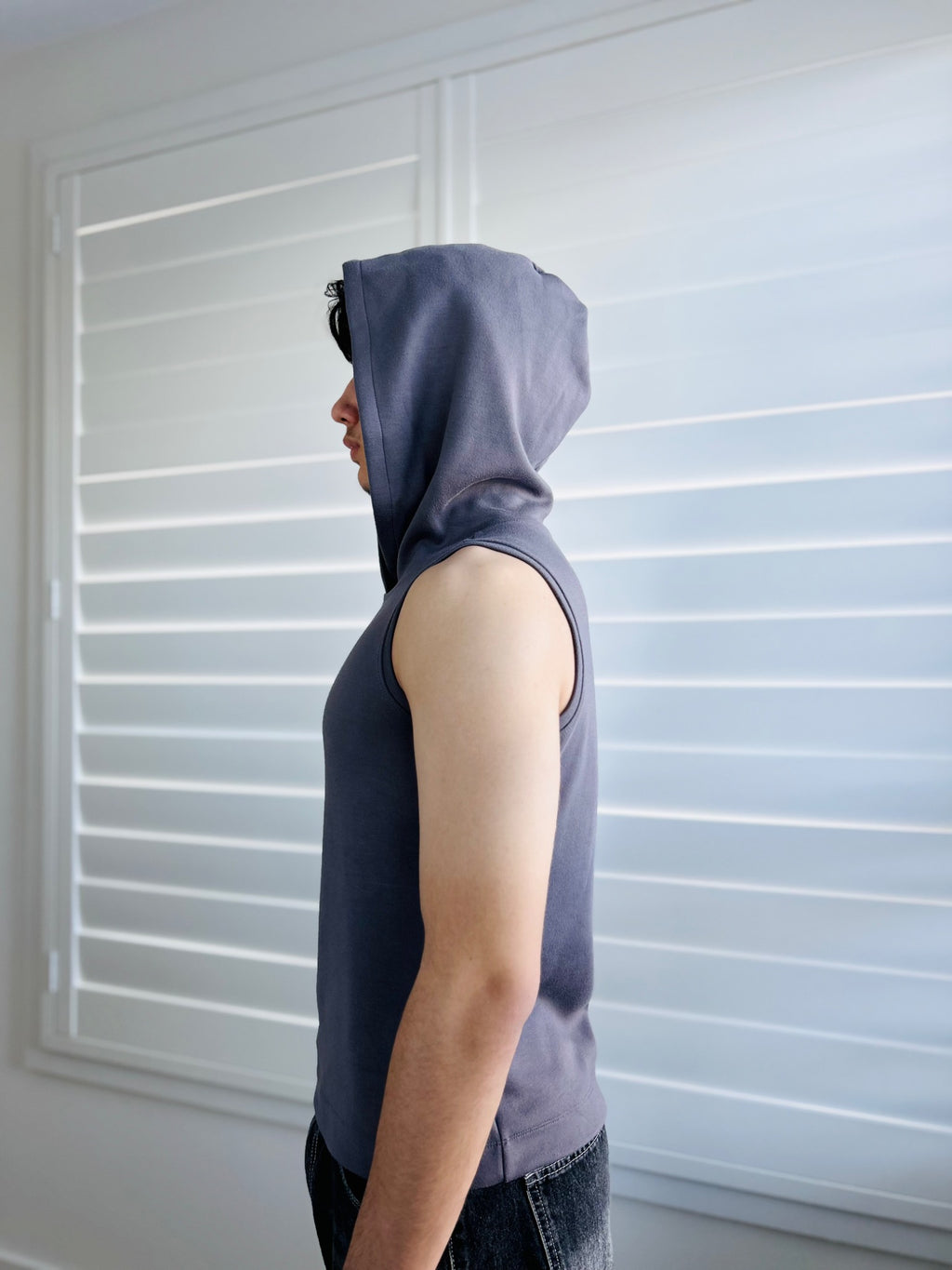 BIKINMOR Core Sleeveless Hoodie in Stone Grey side view with hood up
