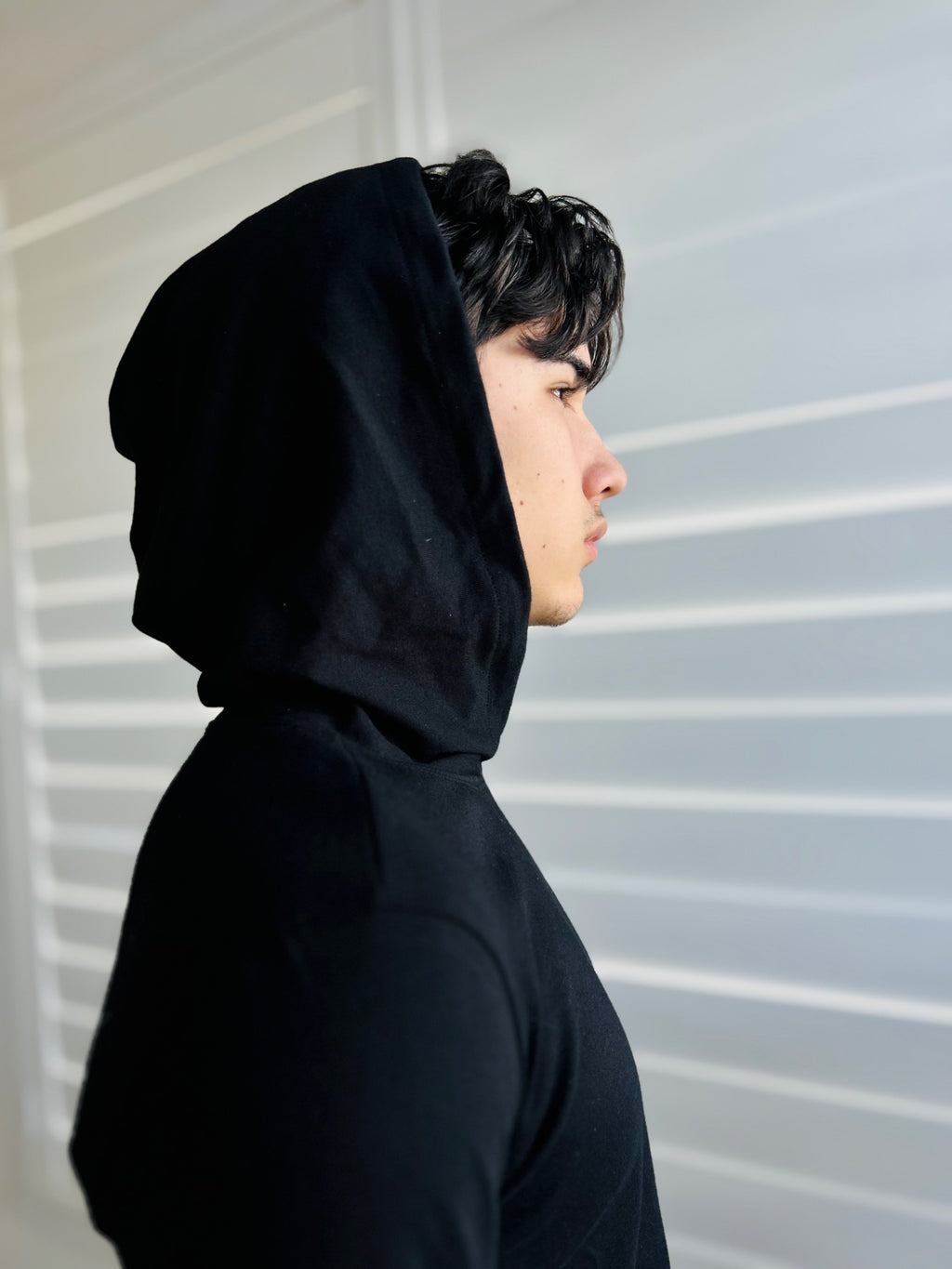 BIKINMOR Slim Fit Long Sleeve Hoodie in Santa Fe Black, size XS, hood up side profile