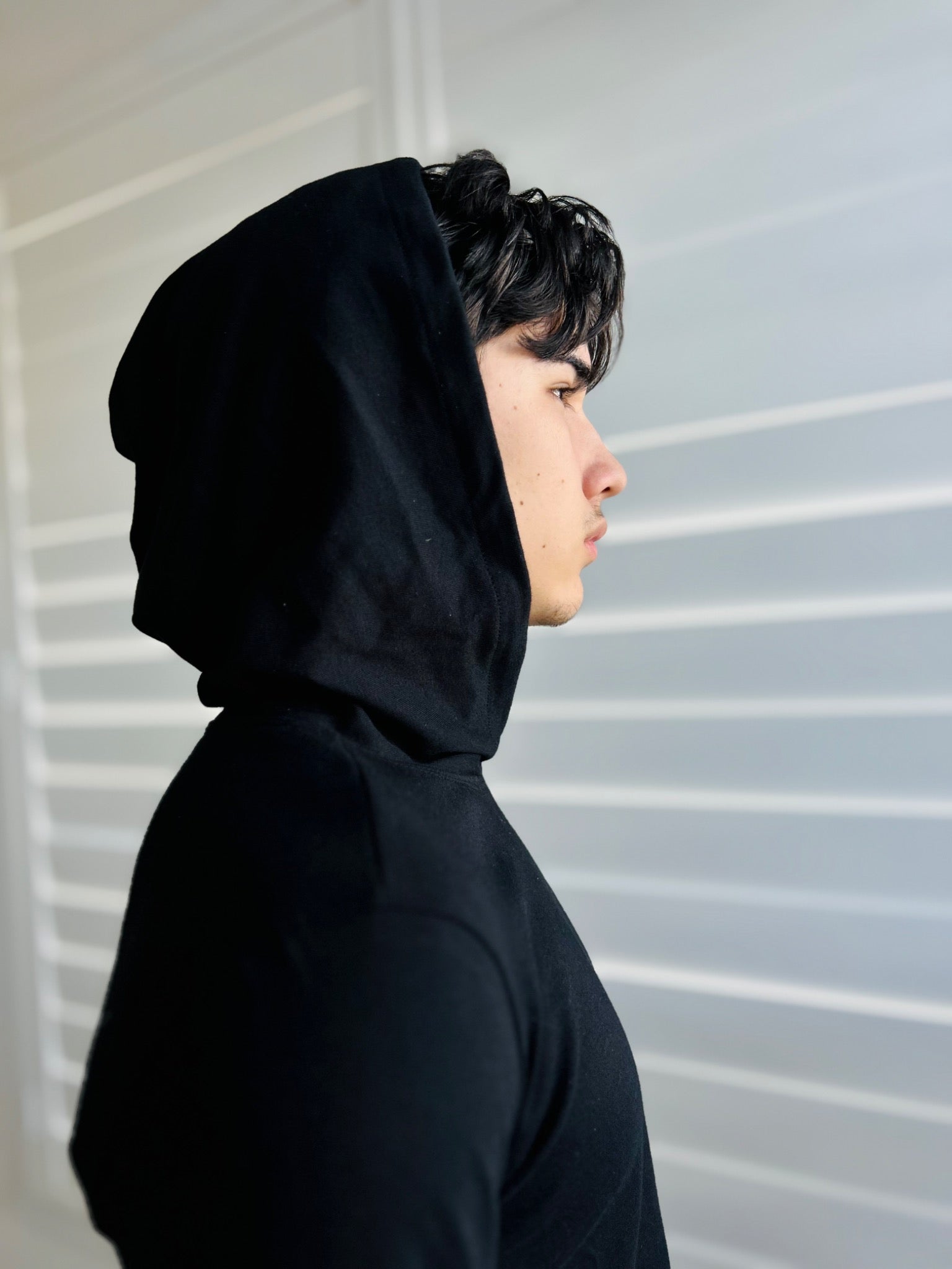 BIKINMOR Slim Fit Long Sleeve Hoodie in Santa Fe Black, size XS, hood up side profile