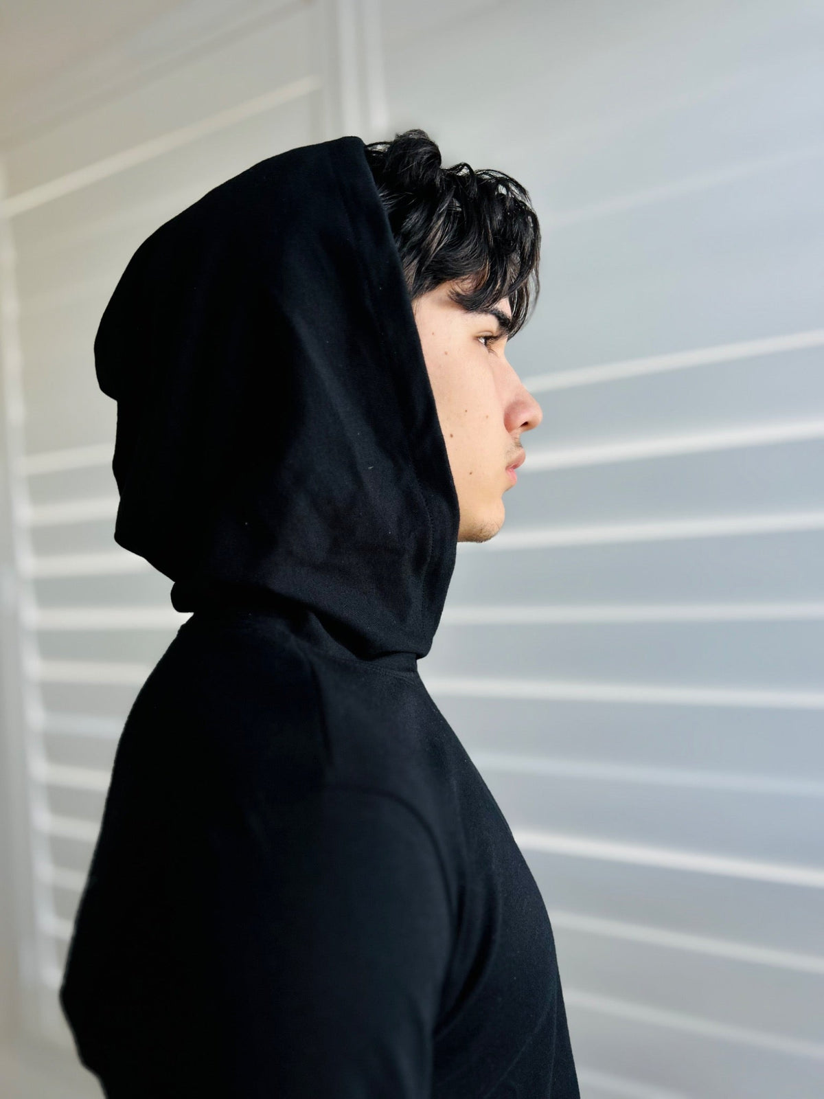 BIKINMOR Slim Fit Long Sleeve Hoodie in Santa Fe Black, size XS, hood up side profile